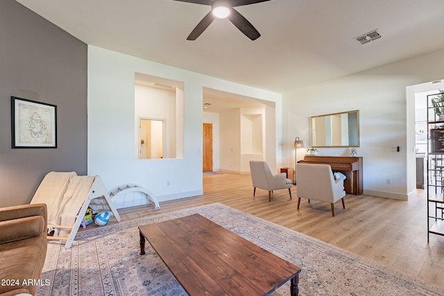 living room with light hardwood / wood-style floors and ceiling fan