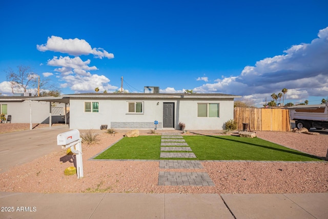 view of front of property featuring a front lawn and a carport