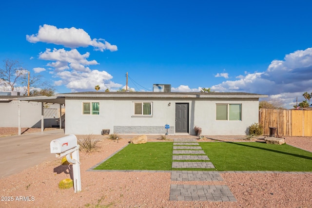 single story home featuring a front yard and a carport