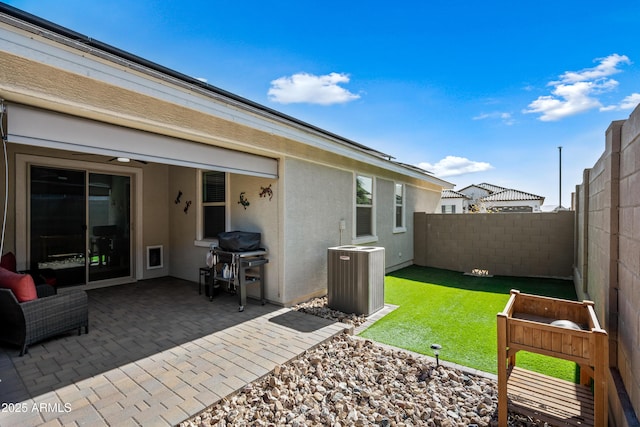 exterior space with central AC, a yard, and a patio