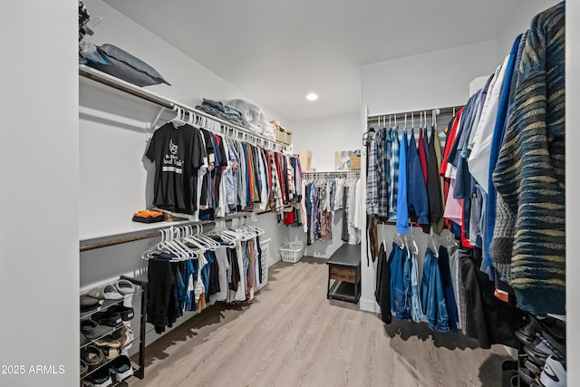 spacious closet with light hardwood / wood-style floors