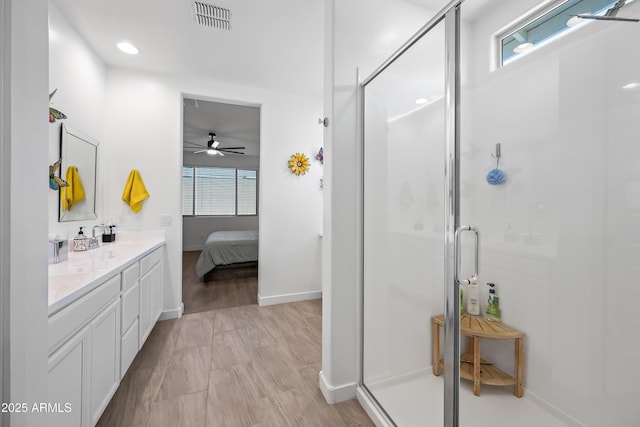 bathroom with ceiling fan, vanity, and an enclosed shower