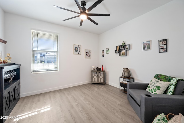 living area featuring light hardwood / wood-style floors and ceiling fan