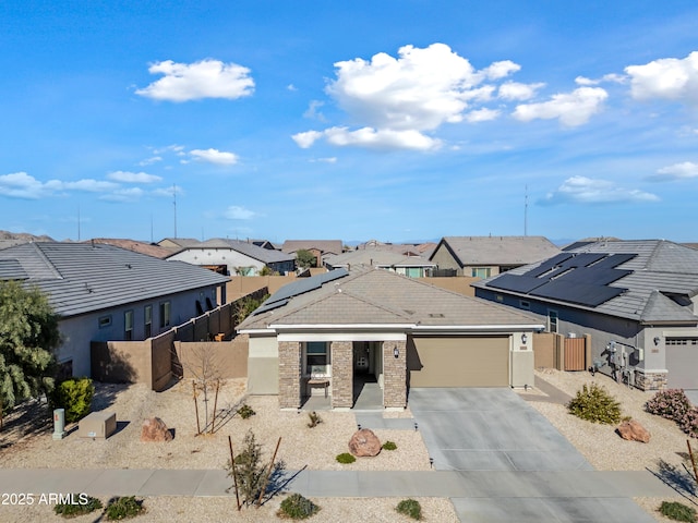 view of front facade with solar panels and a garage