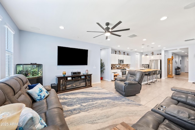 living room with ceiling fan and light tile patterned floors