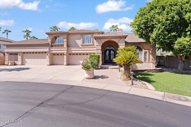 mediterranean / spanish-style house with a chimney, stucco siding, fence, and concrete driveway
