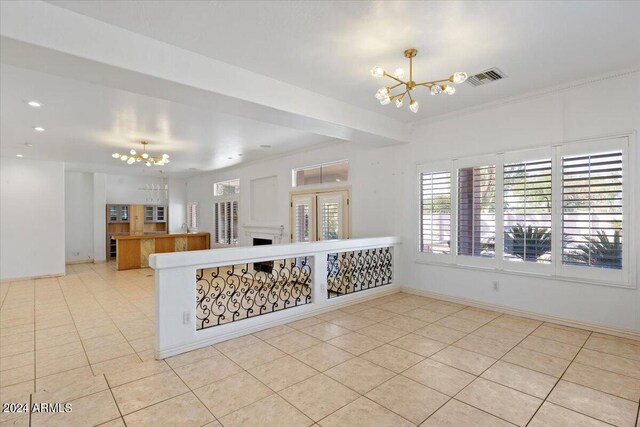 kitchen featuring ornamental molding, a notable chandelier, light tile patterned floors, and butcher block countertops