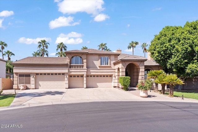 mediterranean / spanish-style house with a garage