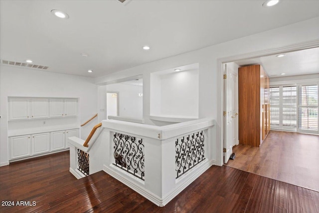 corridor with dark hardwood / wood-style floors