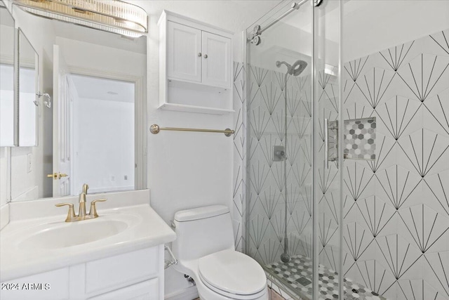 bathroom with walk in shower, vanity, and toilet