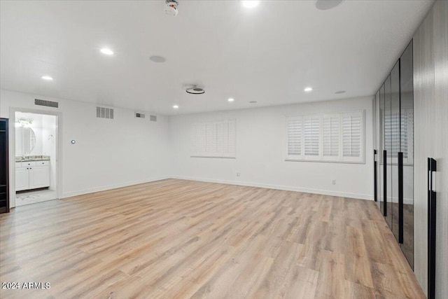 unfurnished room with light wood-type flooring