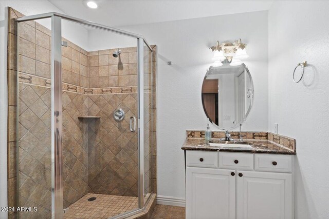 bathroom featuring walk in shower and vanity