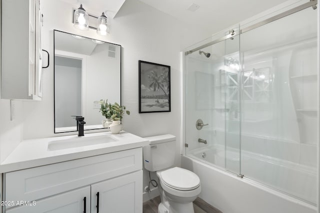 full bathroom with toilet, vanity, and shower / bath combination with glass door