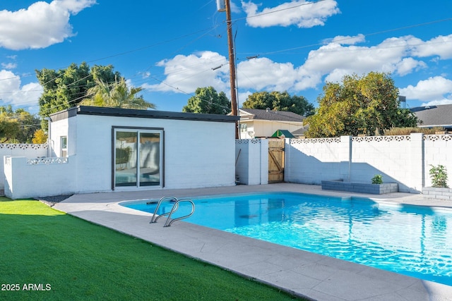 view of pool featuring a yard and a patio