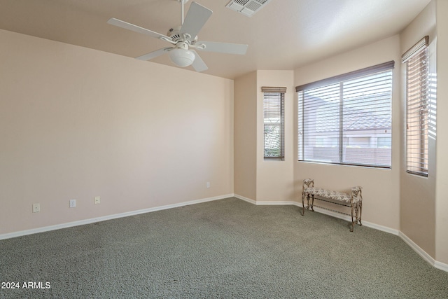 unfurnished room with carpet and ceiling fan