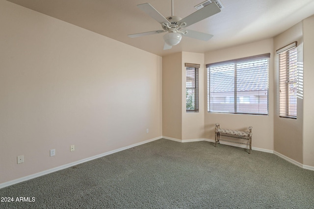 carpeted empty room featuring ceiling fan