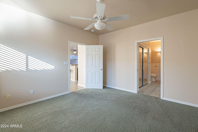 unfurnished bedroom with ensuite bathroom, ceiling fan, and light carpet