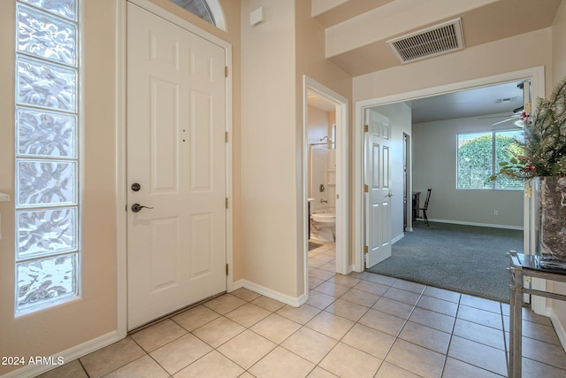 entryway with ceiling fan and light tile patterned floors