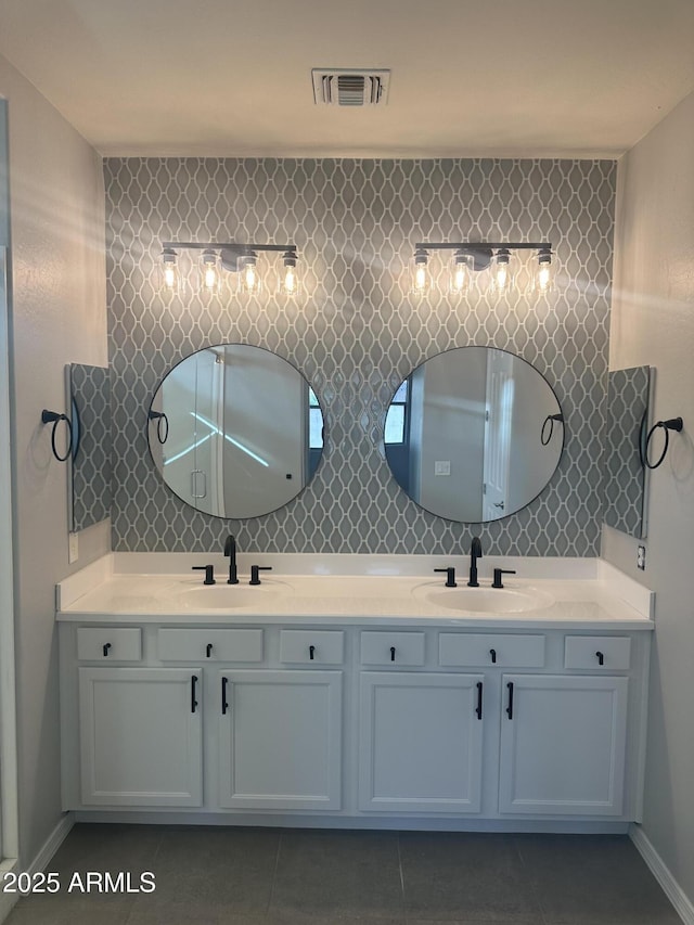 bathroom featuring double vanity, visible vents, and a sink