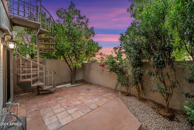 view of patio terrace at dusk