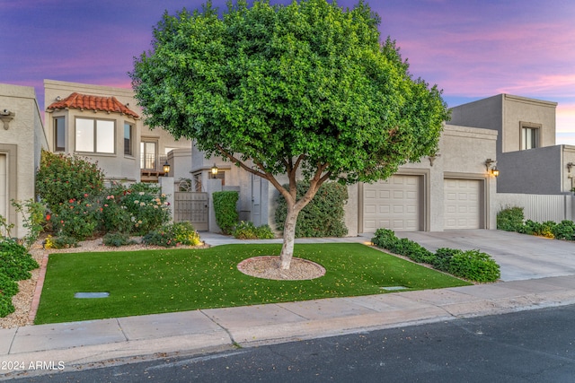 view of front of property featuring a yard and a garage