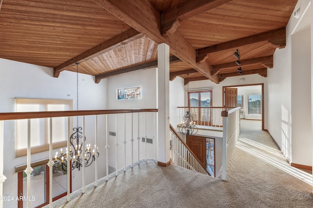 hall featuring vaulted ceiling with beams, carpet floors, wood ceiling, and an inviting chandelier