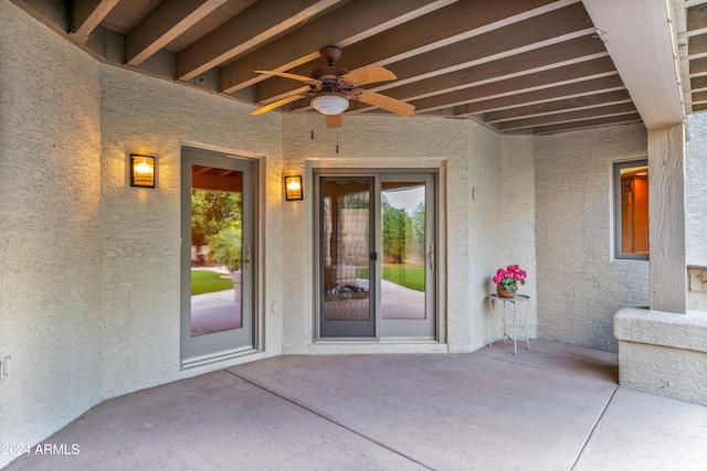 property entrance featuring ceiling fan and a patio area