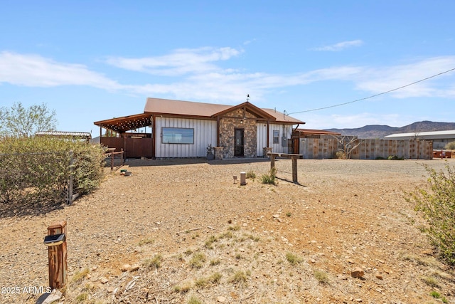 10975 E Janet Way, Dewey, AZ 86327 - view of front of house featuring board and batten siding, fence, and a mountain view