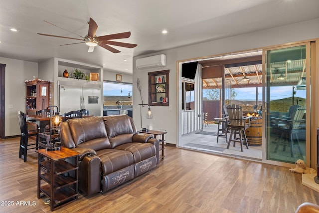 10975 E Janet Way, Dewey, AZ 86327 - living room with a wall unit AC, a ceiling fan, wood finished floors, baseboards, and recessed lighting