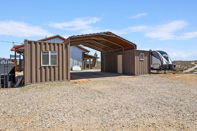 10975 E Janet Way, Dewey, AZ 86327 - view of outbuilding with driveway, an outbuilding, and a carport