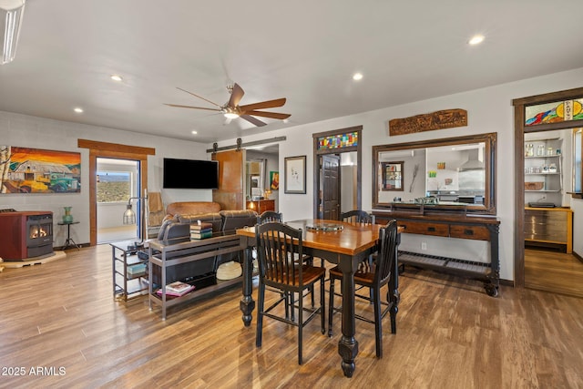 10975 E Janet Way, Dewey, AZ 86327 - dining space featuring recessed lighting, ceiling fan, wood finished floors, and a wood stove