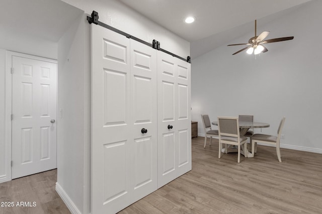 13636 N Hamilton Dr Unit 101, Fountain Hills, AZ 85268 - dining area featuring ceiling fan, a barn door, baseboards, and light wood finished floors