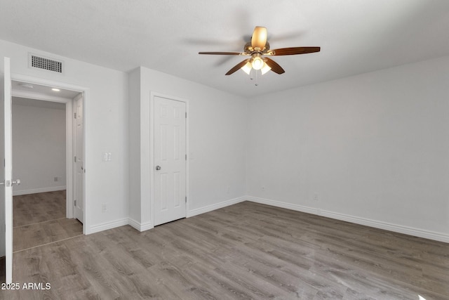 13636 N Hamilton Dr Unit 101, Fountain Hills, AZ 85268 - unfurnished bedroom with visible vents, baseboards, ceiling fan, and wood finished floors