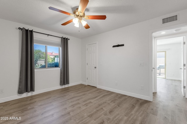 13636 N Hamilton Dr Unit 101, Fountain Hills, AZ 85268 - unfurnished room featuring baseboards, ceiling fan, visible vents, and wood finished floors