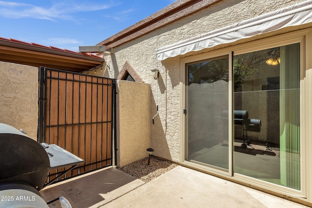 13636 N Hamilton Dr Unit 101, Fountain Hills, AZ 85268 - view of exterior entry with a gate and stucco siding