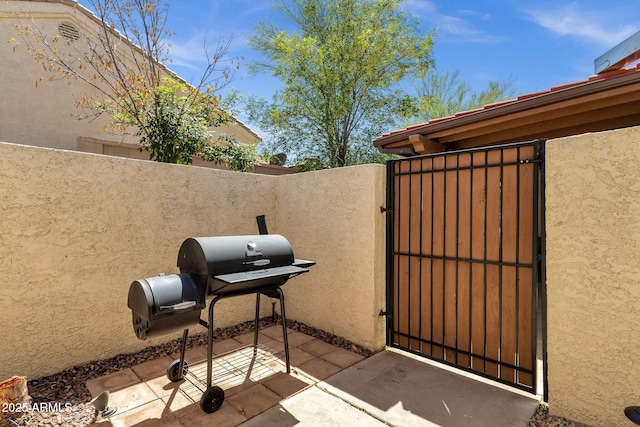 13636 N Hamilton Dr Unit 101, Fountain Hills, AZ 85268 - view of patio with area for grilling, fence, and a gate
