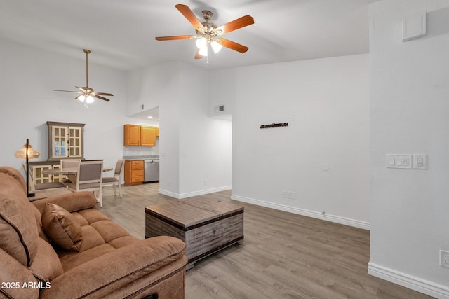 13636 N Hamilton Dr Unit 101, Fountain Hills, AZ 85268 - living room featuring ceiling fan, baseboards, light wood finished floors, and high vaulted ceiling