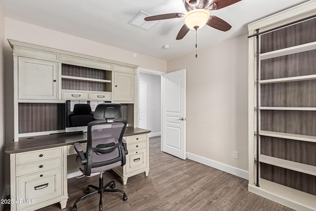 office space featuring wood finished floors, visible vents, a ceiling fan, and baseboards
