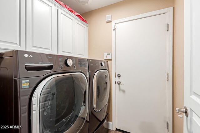 clothes washing area featuring cabinet space and washer and dryer