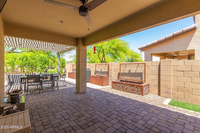 view of patio with a ceiling fan, outdoor dining space, and a fenced backyard