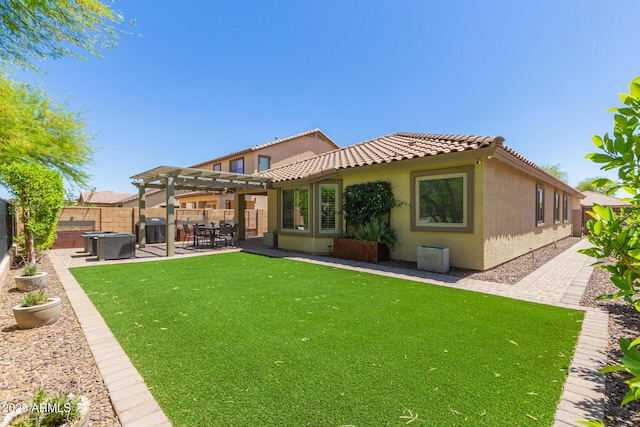 rear view of house featuring a tiled roof, a fenced backyard, a pergola, a patio area, and stucco siding