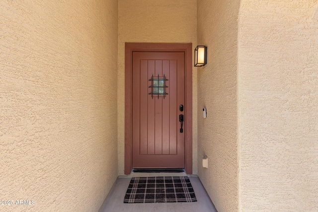 doorway to property with stucco siding