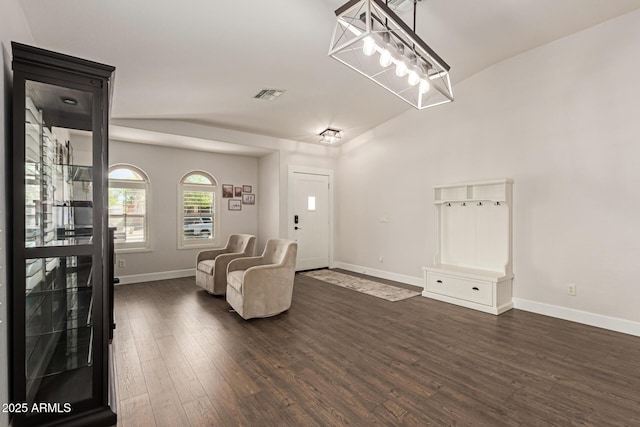 sitting room with baseboards, visible vents, and dark wood-style floors
