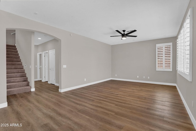 3376 E Lafayette Ave, Gilbert, AZ 85298 - unfurnished room featuring a ceiling fan, wood finished floors, stairs, arched walkways, and recessed lighting