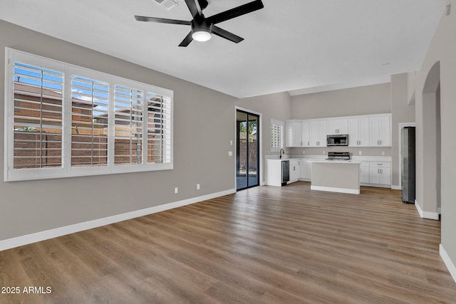3376 E Lafayette Ave, Gilbert, AZ 85298 - unfurnished living room with ceiling fan, light wood-style floors, and high vaulted ceiling