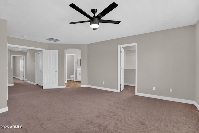 3376 E Lafayette Ave, Gilbert, AZ 85298 - unfurnished bedroom featuring arched walkways, carpet floors, a walk in closet, and ensuite bath