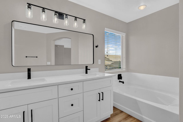 3376 E Lafayette Ave, Gilbert, AZ 85298 - bathroom featuring double vanity, a bath, and wood finished floors