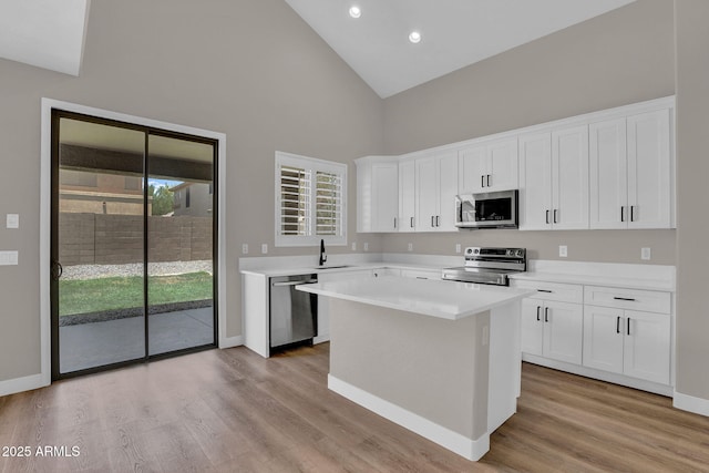 3376 E Lafayette Ave, Gilbert, AZ 85298 - kitchen featuring stainless steel appliances, high vaulted ceiling, light wood-style flooring, white cabinets, and recessed lighting
