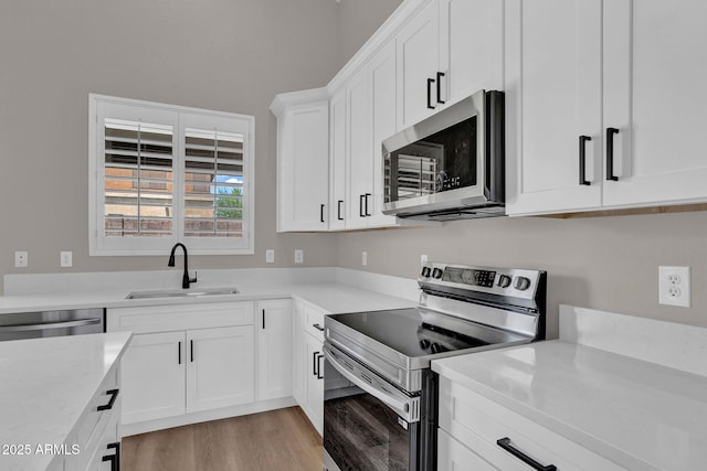 3376 E Lafayette Ave, Gilbert, AZ 85298 - kitchen featuring appliances with stainless steel finishes, light wood-style floors, and white cabinets