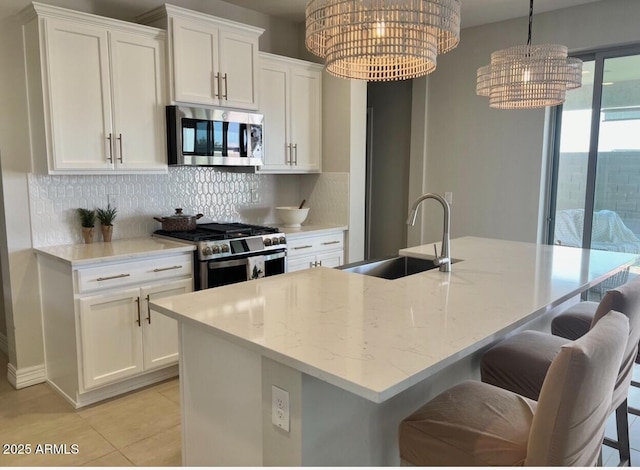 kitchen with white cabinetry, sink, a center island with sink, and appliances with stainless steel finishes